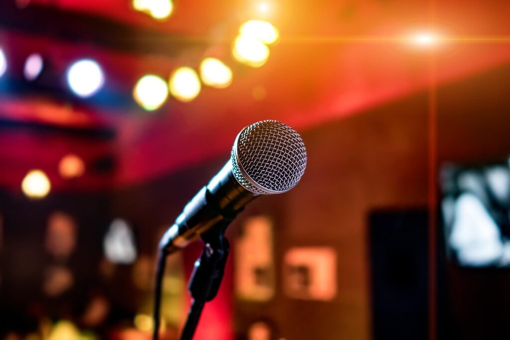 a microphone on a stand with an orange hue