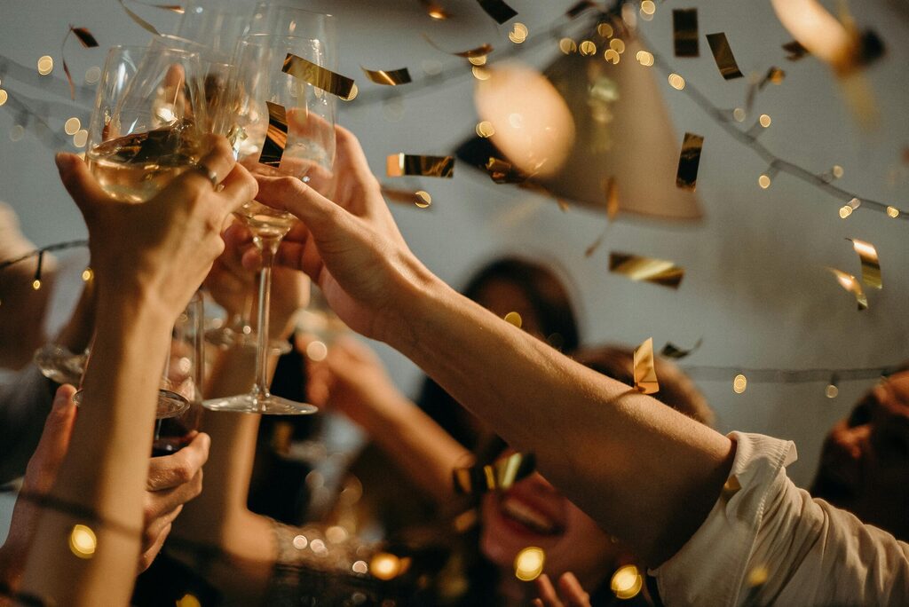 hands celebrating at a party with alcohol