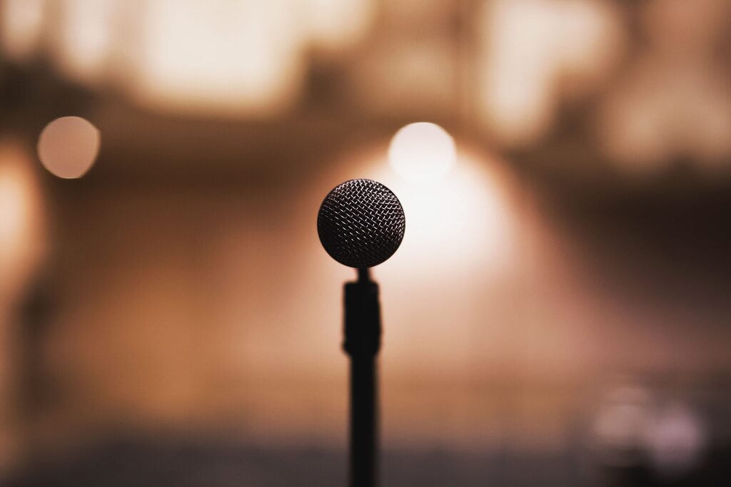 a mic on a microphone stand with yellow blurred background