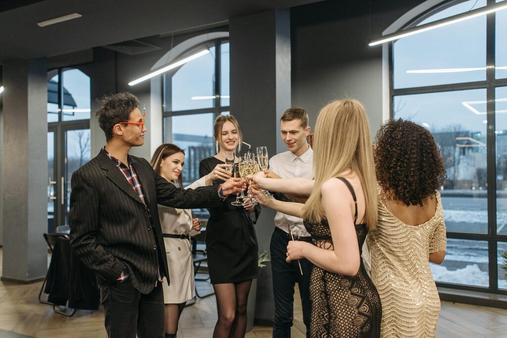 corporate party with 2 men and 3 women cheering having a good time